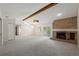 Spacious living room with brick fireplace, ceiling fan, and lots of natural light at 1869 Springbush Ln, Clearwater, FL 33763