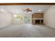 Open-concept living room featuring a brick fireplace, and sliding glass doors to the backyard at 1869 Springbush Ln, Clearwater, FL 33763