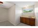 A charming wet bar area with wood cabinets, sink, and window with natural light at 1869 Springbush Ln, Clearwater, FL 33763