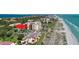 Aerial view of the condo building complex, showcasing its proximity to the beach at 2045 Gulf Of Mexico Dr # M1-514, Longboat Key, FL 34228