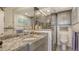 Beautiful bathroom with a glass shower, granite countertop, and storage at 2045 Gulf Of Mexico Dr # M1-514, Longboat Key, FL 34228