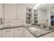 Bathroom with granite countertops, ample storage, and well-lit vanity at 2045 Gulf Of Mexico Dr # M1-514, Longboat Key, FL 34228