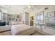 Bright bedroom features mirrored wall, ceiling fan, ensuite bathroom access, and lots of natural light at 2045 Gulf Of Mexico Dr # M1-514, Longboat Key, FL 34228