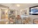 Bright dining area with a glass table and views into the kitchen at 2045 Gulf Of Mexico Dr # M1-514, Longboat Key, FL 34228