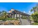 Landscaped entrance to the community with architectural detail and mature plantings at 2045 Gulf Of Mexico Dr # M1-514, Longboat Key, FL 34228