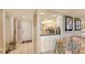 Entry view of updated kitchen with white cabinets, granite counters, and tiled floor at 2045 Gulf Of Mexico Dr # M1-514, Longboat Key, FL 34228