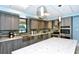 Modern kitchen with stainless steel appliances, granite countertops, and a stylish backsplash at 2045 Gulf Of Mexico Dr # M1-514, Longboat Key, FL 34228