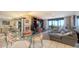 Bright living room with tile floors, comfortable seating, and ocean view balcony access at 2045 Gulf Of Mexico Dr # M1-514, Longboat Key, FL 34228