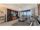Inviting living room with built-in shelving and access to balcony at 2045 Gulf Of Mexico Dr # M1-514, Longboat Key, FL 34228
