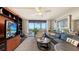 Relaxing living room with balcony access and sleek entertainment center at 2045 Gulf Of Mexico Dr # M1-514, Longboat Key, FL 34228
