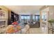 Open-concept living space with seamless flow to the balcony and dining area at 2045 Gulf Of Mexico Dr # M1-514, Longboat Key, FL 34228