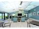 A cozy lounge with plush seating, a large TV, and views of the ocean beyond at 2045 Gulf Of Mexico Dr # M1-514, Longboat Key, FL 34228