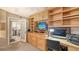 Well-lit office features built-in shelving, a workspace, and access to other rooms at 2045 Gulf Of Mexico Dr # M1-514, Longboat Key, FL 34228