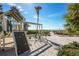 Community playground with swings, climbing wall, and path to beach under sunny skies at 2045 Gulf Of Mexico Dr # M1-514, Longboat Key, FL 34228