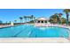 Spacious community pool with umbrellas and lounge chairs provides a perfect retreat for residents and guests at 2045 Gulf Of Mexico Dr # M1-514, Longboat Key, FL 34228