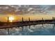 Water reflects a tranquil sunset view at the community swimming pool by the beach at 2045 Gulf Of Mexico Dr # M1-514, Longboat Key, FL 34228