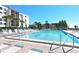 Community pool with clear blue water, ample seating, and umbrellas offers a tranquil place to relax at 2045 Gulf Of Mexico Dr # M1-514, Longboat Key, FL 34228
