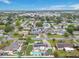 Aerial view of a suburban neighborhood with homes featuring pools, solar panels, and landscaping at 212 66Th Avenue W Dr, Bradenton, FL 34207