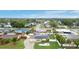 Suburban neighborhood aerial view of a home with a solar-paneled roof, well maintained yard and mature trees at 212 66Th Avenue W Dr, Bradenton, FL 34207
