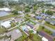 Wide angle aerial view of a suburban neighborhood with homes featuring pools, solar panels, and landscaping at 212 66Th Avenue W Dr, Bradenton, FL 34207