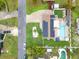 Bird's-eye view of home, showcasing solar panels, a pristine pool, and meticulously landscaped backyard at 212 66Th Avenue W Dr, Bradenton, FL 34207