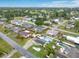 Wide aerial view of a residential neighborhood featuring a home with pool, solar panels, and lush landscaping at 212 66Th Avenue W Dr, Bradenton, FL 34207