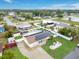 Aerial view of home boasting a solar-paneled roof, refreshing pool, and meticulously landscaped yard at 212 66Th Avenue W Dr, Bradenton, FL 34207