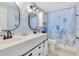 Charming bathroom with ocean themed shower curtain, blue walls, and white vanity at 212 66Th Avenue W Dr, Bradenton, FL 34207