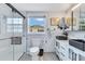Bathroom featuring white tile, black fixtures, and a glass enclosed shower at 212 66Th Avenue W Dr, Bradenton, FL 34207