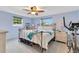 Bright bedroom with ceiling fan, work-out equipment, and comfortable bedding, with views from the windows at 212 66Th Avenue W Dr, Bradenton, FL 34207