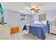Bright bedroom with ceiling fan, TV, comfortable bedding, and views from the window at 212 66Th Avenue W Dr, Bradenton, FL 34207