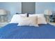 Close-up of a plush bedroom featuring a comfortable bed, accent pillows, and bedside lamps at 212 66Th Avenue W Dr, Bradenton, FL 34207