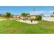 A cozy, one-story home boasts a lush green lawn, vibrant landscaping, and solar panels at 212 66Th Avenue W Dr, Bradenton, FL 34207