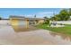 Well-maintained home with a spacious driveway, solar panels, and a lush, landscaped yard at 212 66Th Avenue W Dr, Bradenton, FL 34207