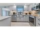 Light and airy kitchen with updated stainless steel appliances and white cabinets at 212 66Th Avenue W Dr, Bradenton, FL 34207