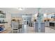 A modern kitchen with light blue walls, white cabinetry, and stainless steel appliances at 212 66Th Avenue W Dr, Bradenton, FL 34207