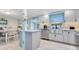 Modern kitchen with light blue walls, white cabinets, and stainless steel appliances at 212 66Th Avenue W Dr, Bradenton, FL 34207