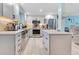 Well-lit modern kitchen featuring white cabinets, stainless steel appliances, and an eat-in breakfast bar at 212 66Th Avenue W Dr, Bradenton, FL 34207