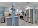 Bright kitchen with white cabinets, stainless steel appliances, modern countertop, and an island at 212 66Th Avenue W Dr, Bradenton, FL 34207