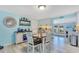 Light blue kitchen with dining table, open layout, and access to the backyard at 212 66Th Avenue W Dr, Bradenton, FL 34207