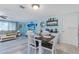 Open-concept living room with dining area, wood floors, modern furnishings, and a bright, airy feel at 212 66Th Avenue W Dr, Bradenton, FL 34207