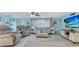 Bright living room with light blue walls, comfortable seating, and large TV at 212 66Th Avenue W Dr, Bradenton, FL 34207