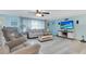 Inviting living room featuring modern furniture, a large TV, and light-filled ambiance at 212 66Th Avenue W Dr, Bradenton, FL 34207