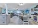 Open-concept living room with modern furnishings, wood floors, TV, and view to other living spaces at 212 66Th Avenue W Dr, Bradenton, FL 34207