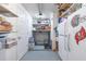 Organized pantry with shelving, storage containers, refrigerator, and functional storage solutions at 212 66Th Avenue W Dr, Bradenton, FL 34207