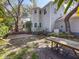 Exterior view of a gray home, showcasing the brick patio and a wooden bench in the backyard at 2306 63Rd W St # 40, Bradenton, FL 34209