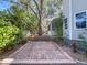 A brick patio and wooden deck lead to the home and feature mature landscaping and a large tree at 2306 63Rd W St # 40, Bradenton, FL 34209