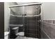 Stylish bathroom offers a modern glass-enclosed shower with dark tile and a decorative accent tile strip at 2306 63Rd W St # 40, Bradenton, FL 34209