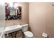 Charming half bathroom with colorful mirror, white fixtures, and neutral wall color at 2306 63Rd W St # 40, Bradenton, FL 34209