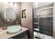 Modern bathroom features a glass vessel sink and a sleek, tiled walk-in shower with pebble flooring at 2306 63Rd W St # 40, Bradenton, FL 34209